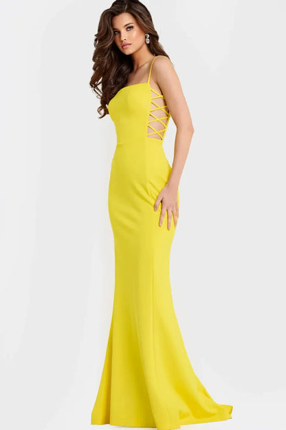 Bold yellow crepe evening dress with spaghetti straps, square neck, lace-up side cut-outs, and mermaid skirt with train
