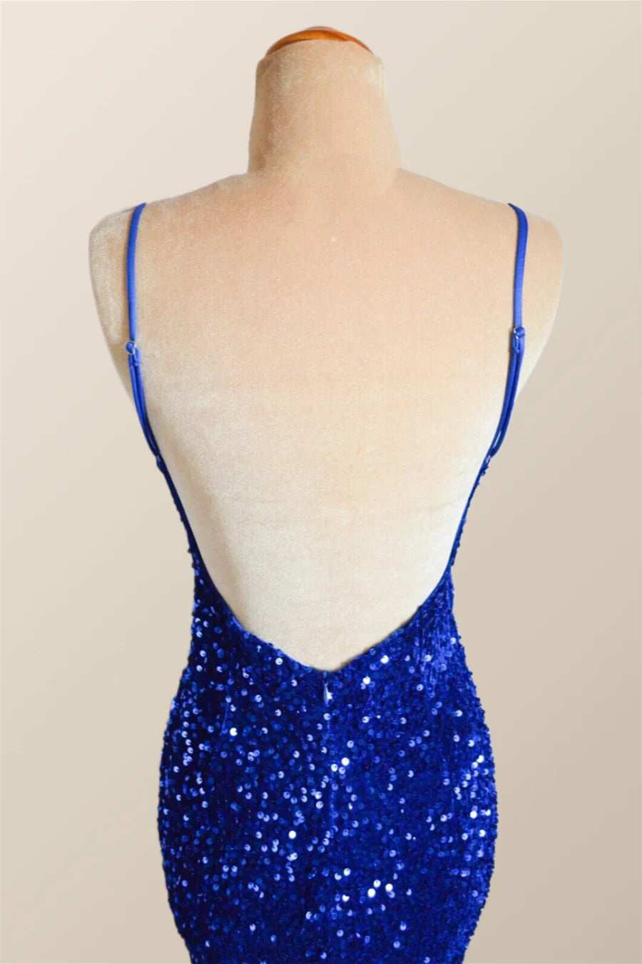 Back view of a model in a sparkling dark sequin mermaid dress, showcasing the elegant low V-back design.