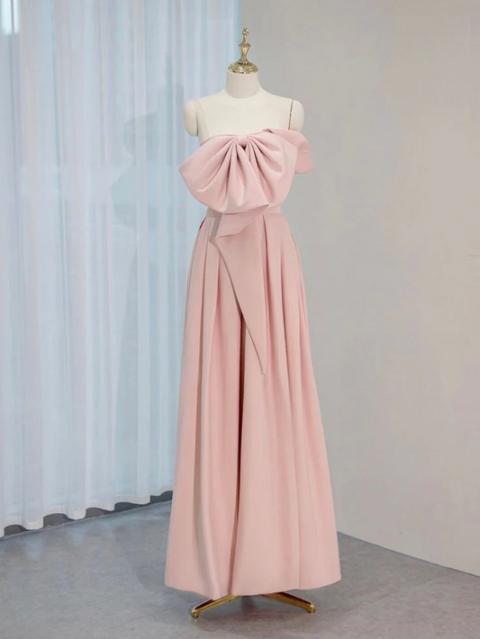 Pink ball gown prom dress with large bow and corset back.