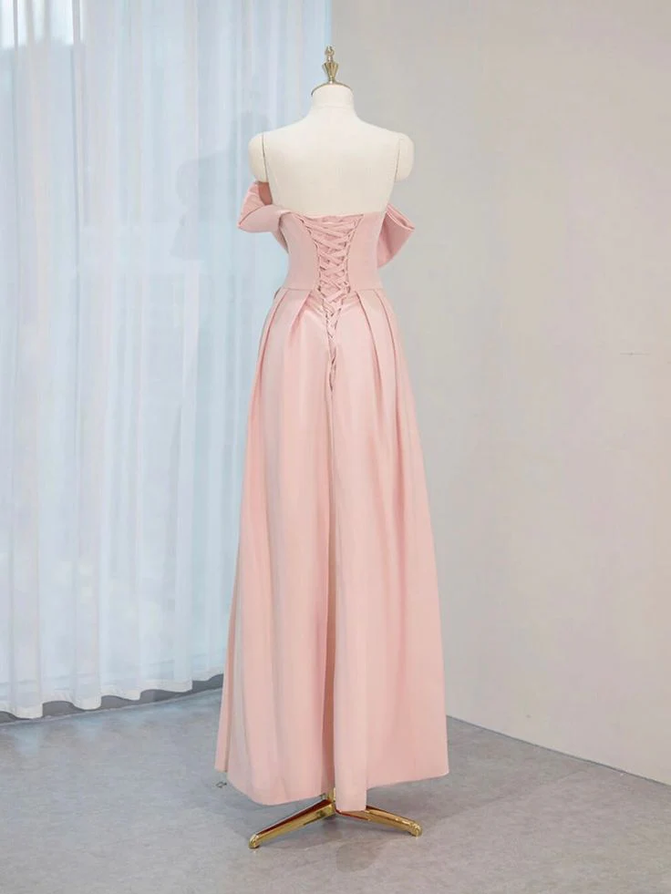 Close-up of strapless neckline and large bow on pink prom dress.