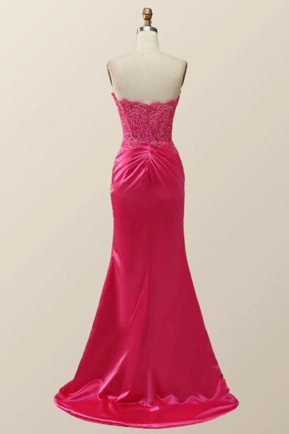 Back view of a model in a lace-up corset mermaid evening dress.