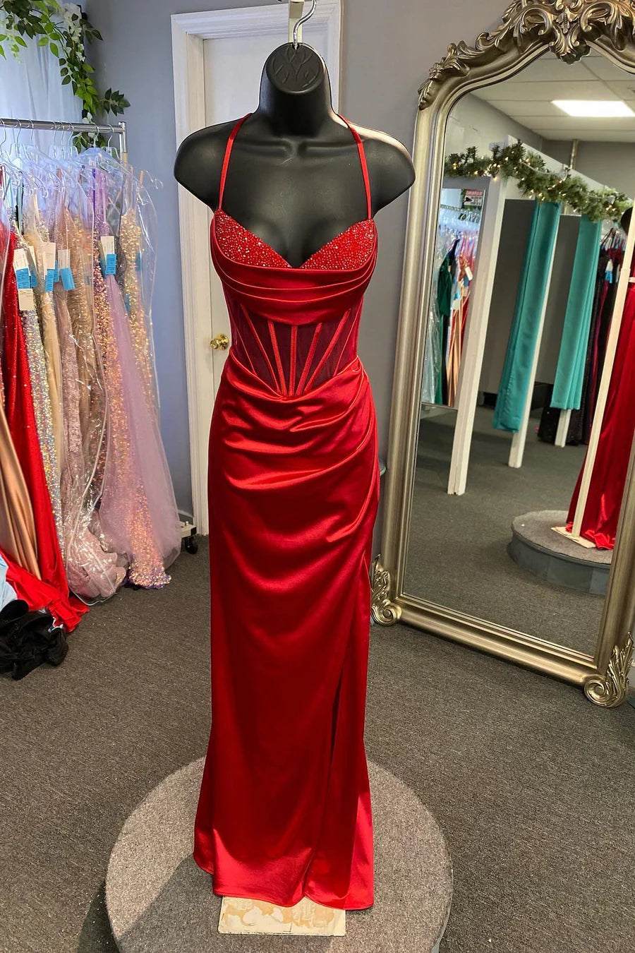 Side profile of mermaid evening dress highlighting high slit and train.