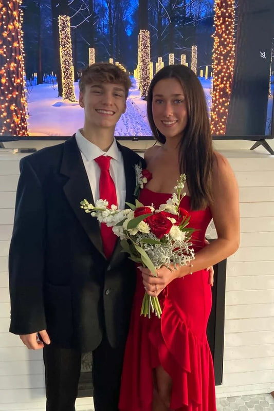 Model wearing an elegant strapless crepe high-low ruffle prom dress.