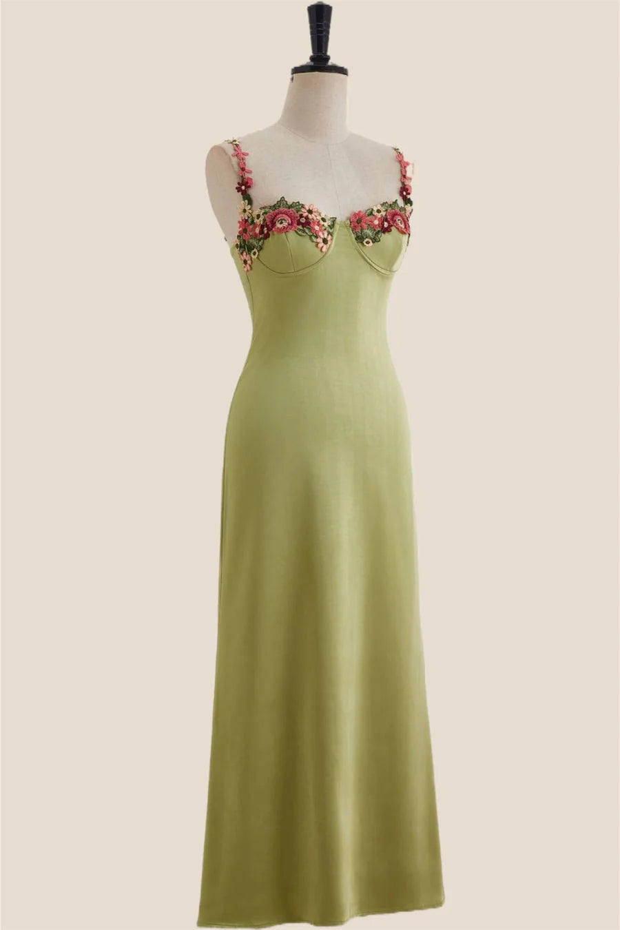 Close-up of sweetheart neckline and floral embroidery on satin dress.