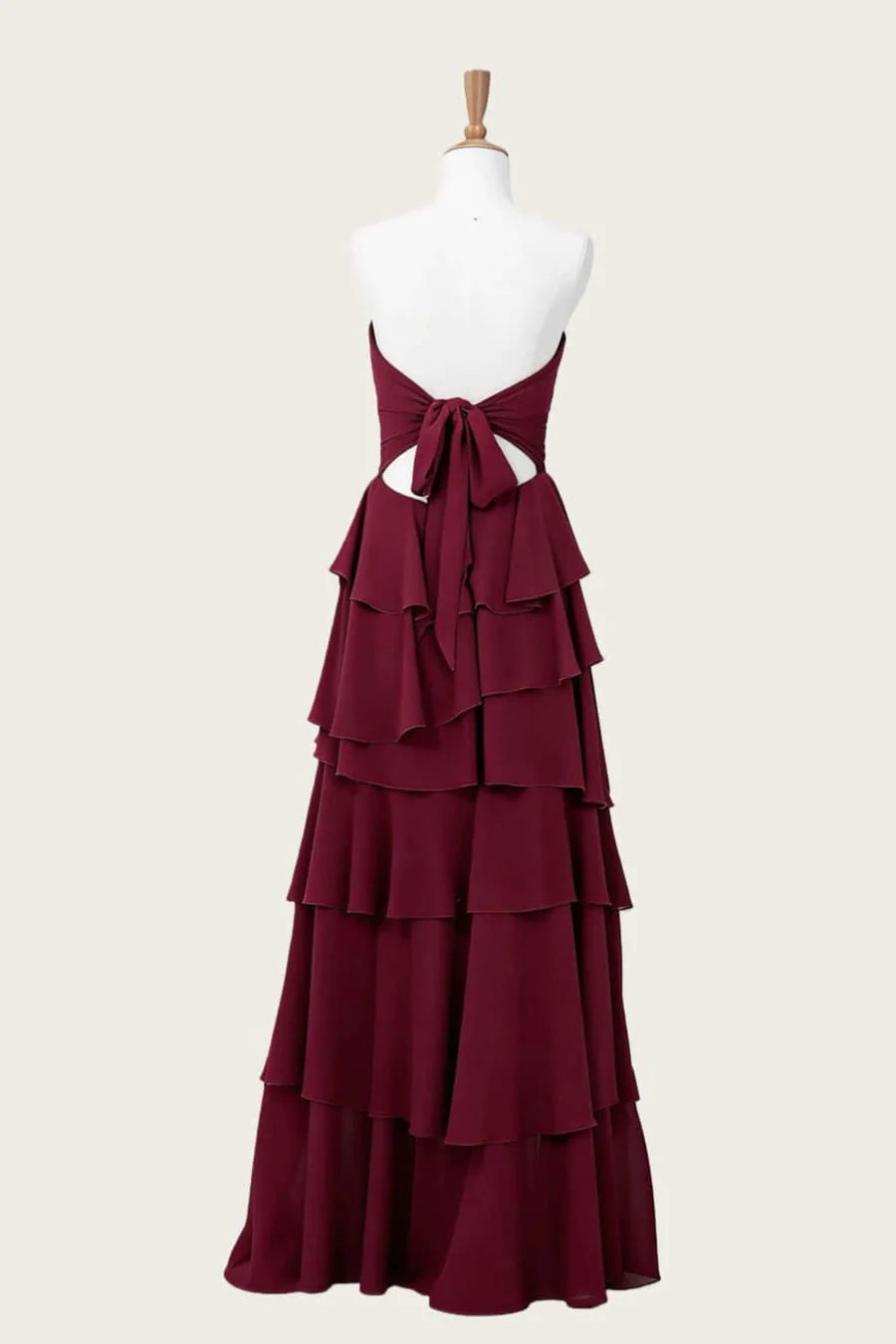 Elegant flowy chiffon A-line strapless high-low burgundy evening dress with tie-back, back view.