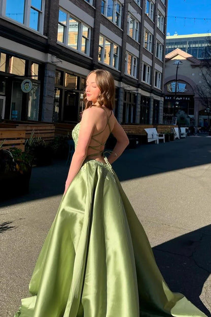 Woman wearing a romantic satin A-line evening dress with spaghetti straps.