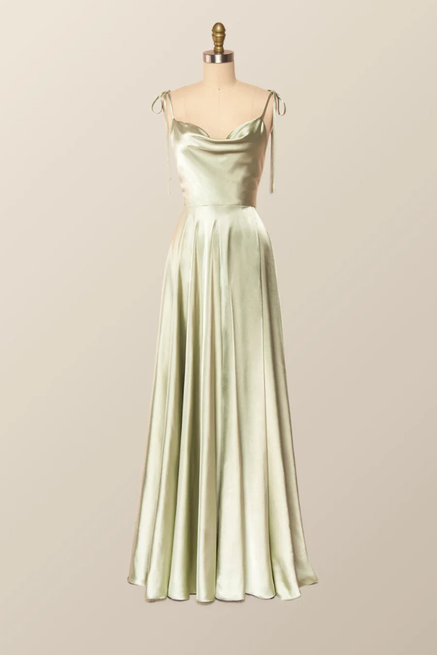 Model walking in a flowy satin A-line evening gown, showcasing its drape.