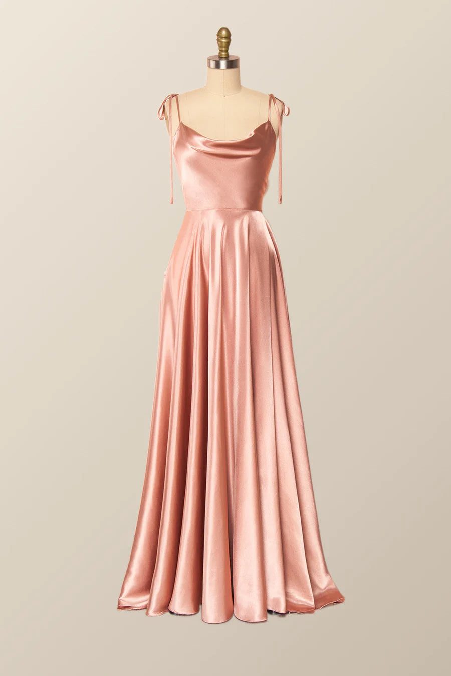 Model posing in a lustrous satin A-line evening gown for formal events.