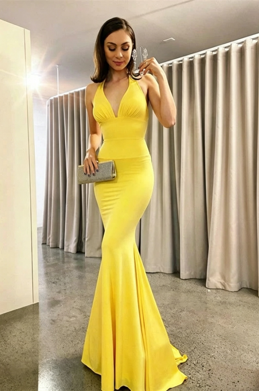 Elegant yellow mermaid prom dress with halter V-neck and fitted silhouette.
