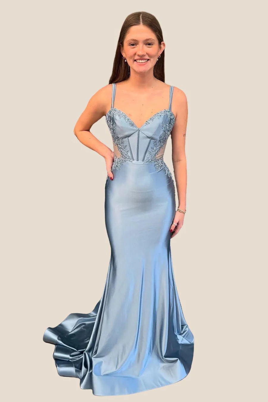 Back view of satin mermaid dress, featuring low open back and V-shaped lace trim.