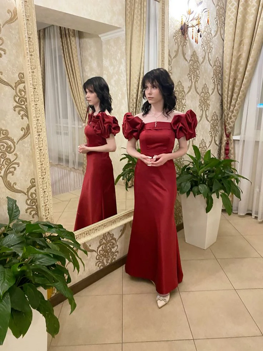 Model wearing an elegant satin mermaid off-shoulder puff-sleeve prom dress.