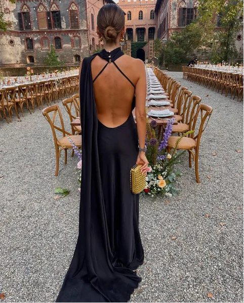 Side view of elegant satin mermaid prom dress showing floor-length skirt.