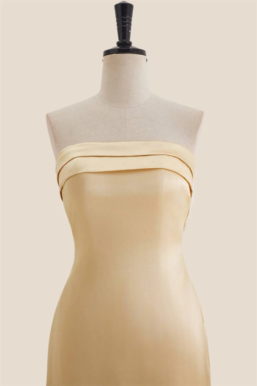 Close-up of the strapless neckline and bodice of the satin dress.