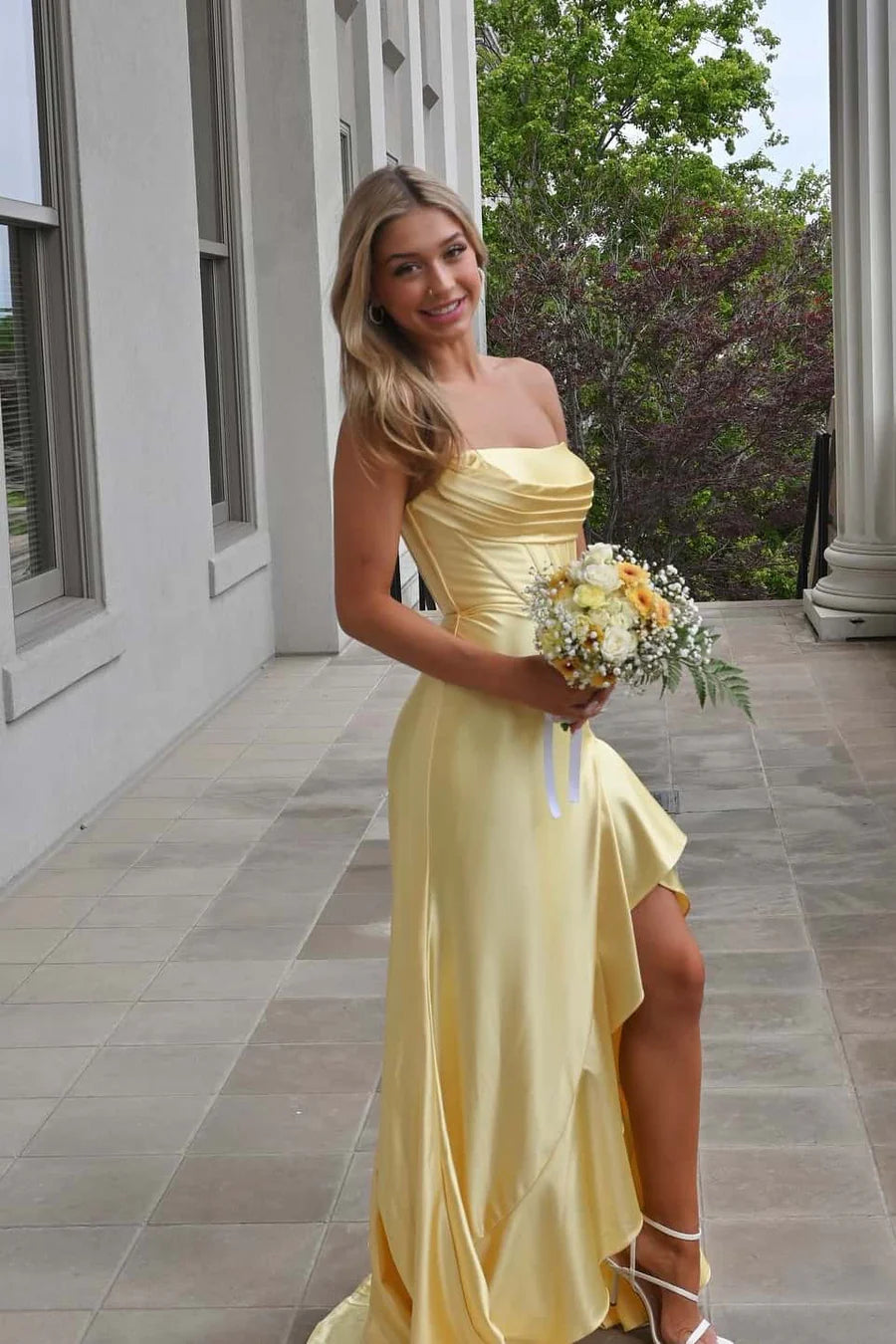 Back view of satin mermaid prom dress featuring a lace-up corset closure.