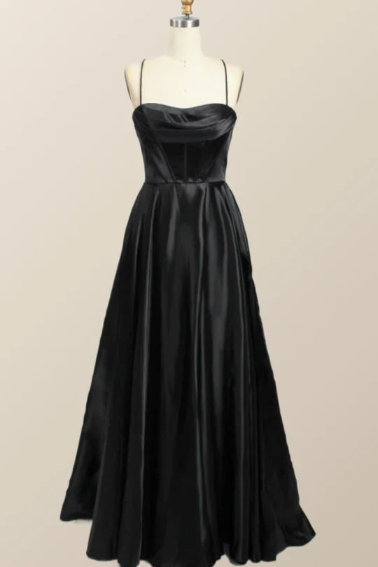 Model wearing a flowy satin A-line cowl-neck evening dress with spaghetti straps and lace-up back.