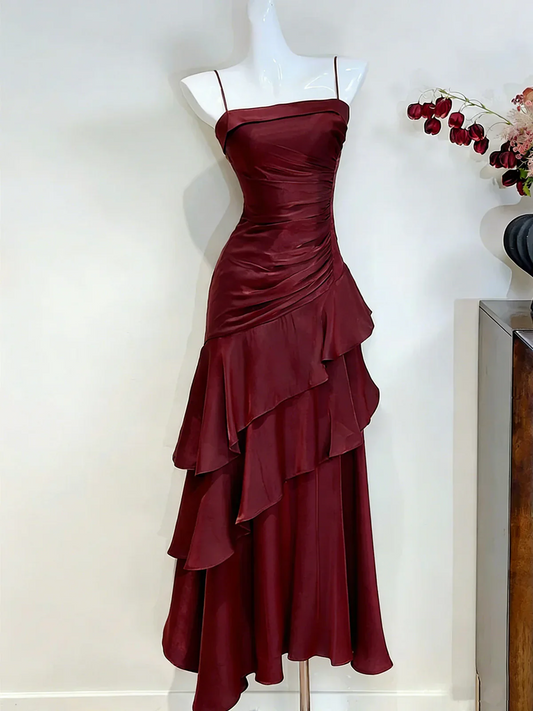 Glamorous metallic mermaid prom dress with straight neck and asymmetric tiered skirt.