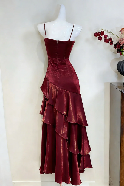 Metallic mermaid prom dress featuring spaghetti straps and ruffled floor-length hem.