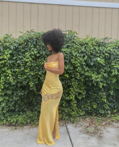 Back view of a model in a satin mermaid prom dress, showcasing the lace-up detail.