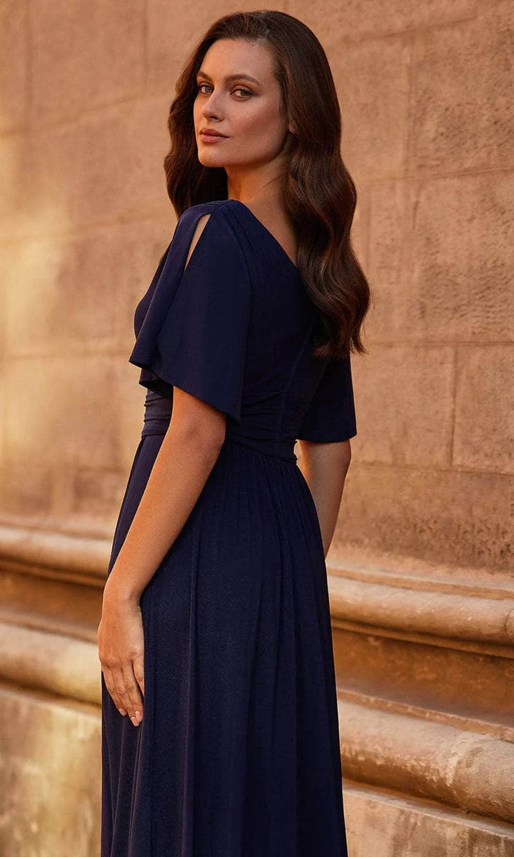 Woman modeling a flowy chiffon A-line V-neck flutter sleeve dress.