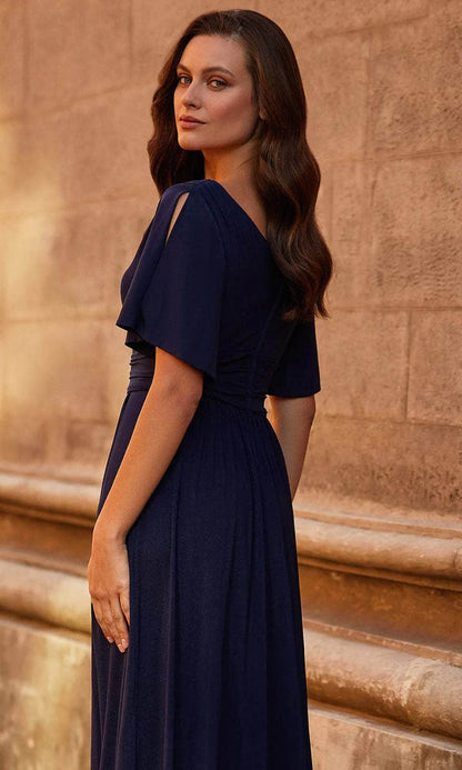 Woman modeling a flowy chiffon A-line V-neck flutter sleeve dress.