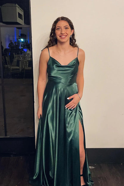 Woman wearing a lustrous satin A-line gown with cowl neck and tie straps.