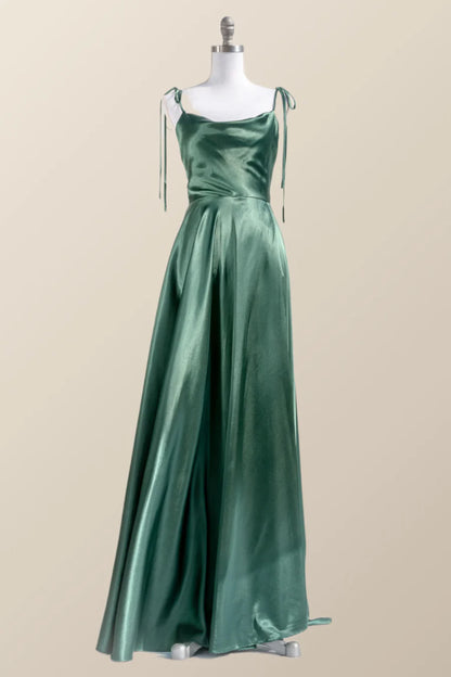 Back view of a woman in a satin gown showing low back and tie straps.