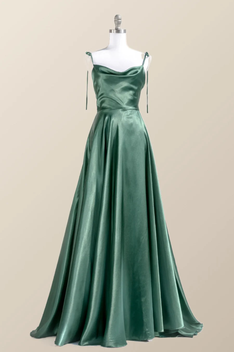 Side view of a woman in a satin gown, highlighting the high slit.