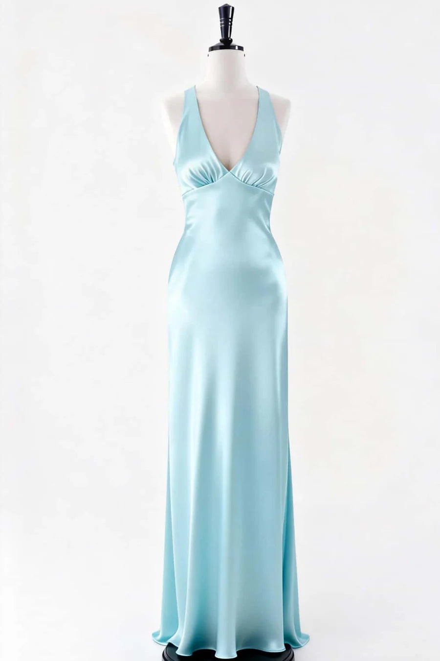 Woman wearing a lustrous satin A-line evening gown with crisscross open back.
