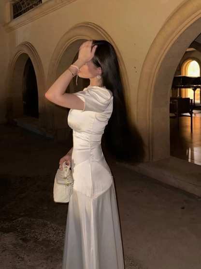 Close-up of the white satin A-line prom dress showing V-neck, puffed sleeves, and ruched waist details.