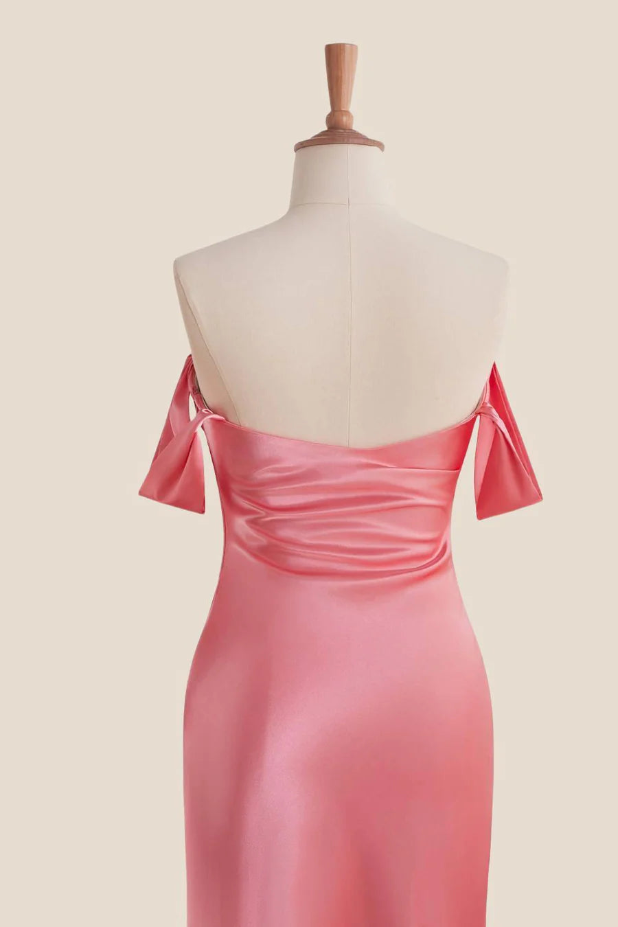Full length view of the elegant satin mermaid evening dress with bow details.