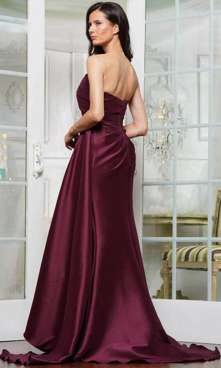 Model posing in a lustrous satin strapless mermaid draped floor-length mother of the bride gown.