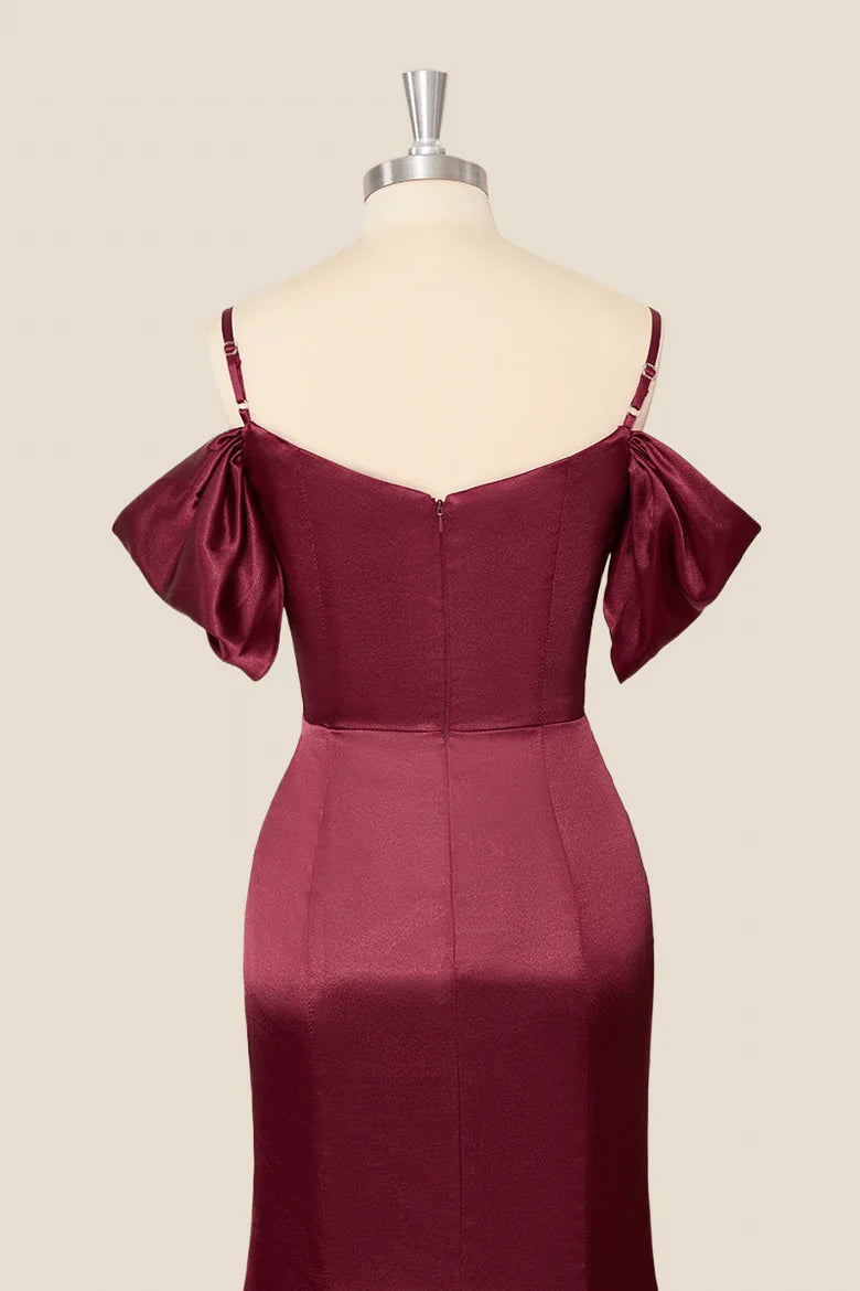Side view of a model in a lustrous satin mermaid dress, highlighting the silhouette.