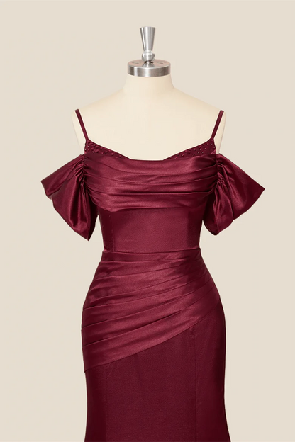 Full-length view of a lustrous satin mermaid evening dress, showcasing the off-shoulder straps.
