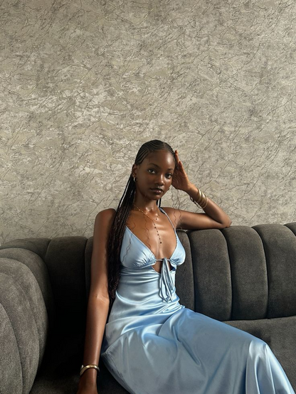 Model wearing a lustrous satin sheath V-neck spaghetti strap tie-back floor-length prom dress.