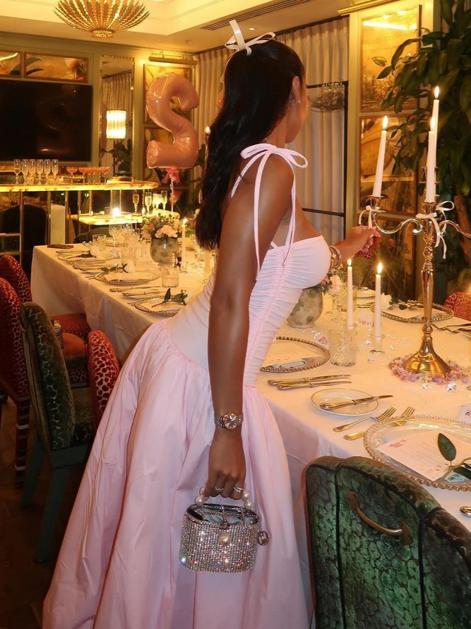 Back view of pink A-line midi prom dress with bubble hem and zipper closure.