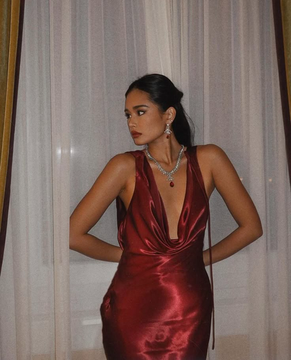 Model in a lustrous satin mermaid prom dress, showing the elegant cowl neckline.