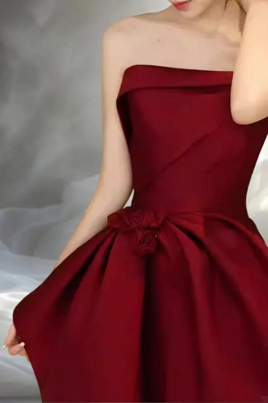 Regal Burgundy Satin Evening Dresses with Strapless Neckline, Floral Bow Detail, Asymmetrical Ruffle Skirt and Floor-Length A-Line Silhouette Formal Gown