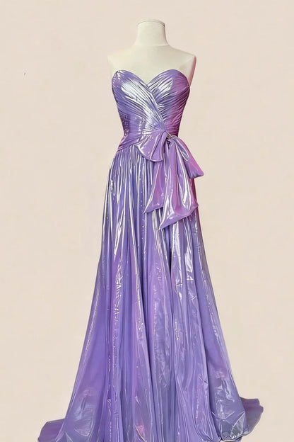 Back view of a shimmery metallic A-line evening dress with a ruched bodice and bow.