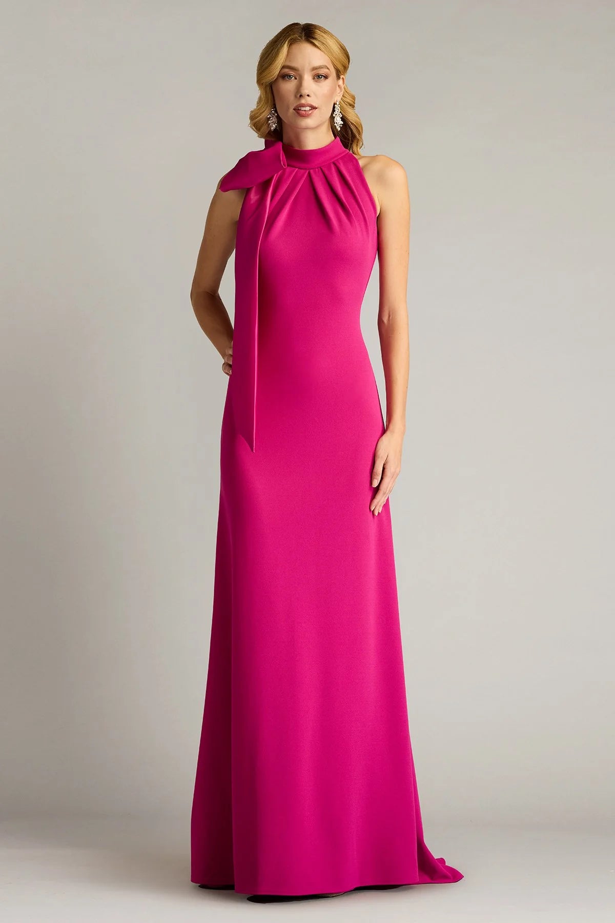 Sleek crepe sheath halter neck sleeveless open back floor length evening dress with oversized satin bow and train