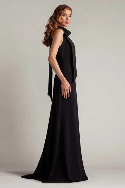 Sleek crepe sheath halter neck sleeveless open back floor length evening dress with oversized satin bow and train