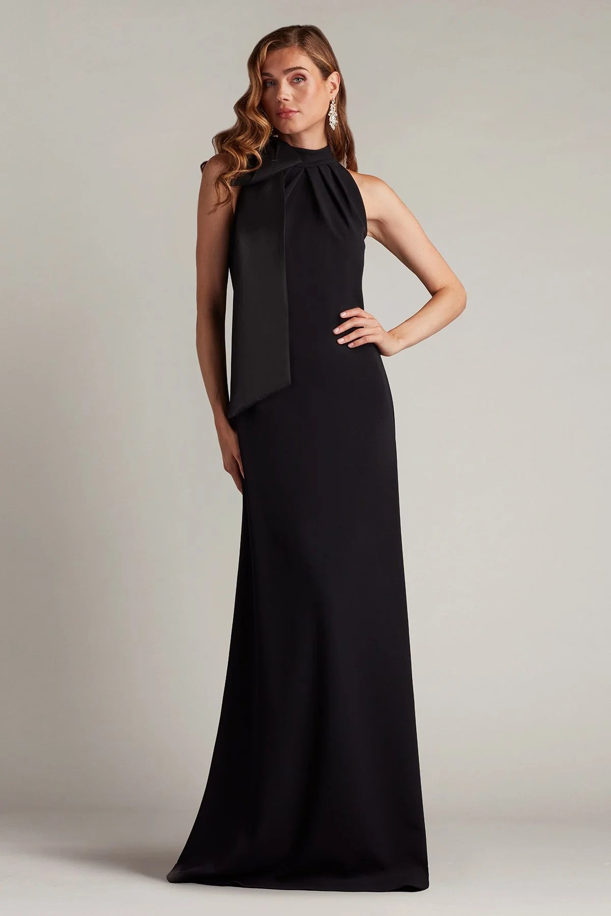 Sleek crepe sheath halter neck sleeveless open back floor length evening dress with oversized satin bow and train