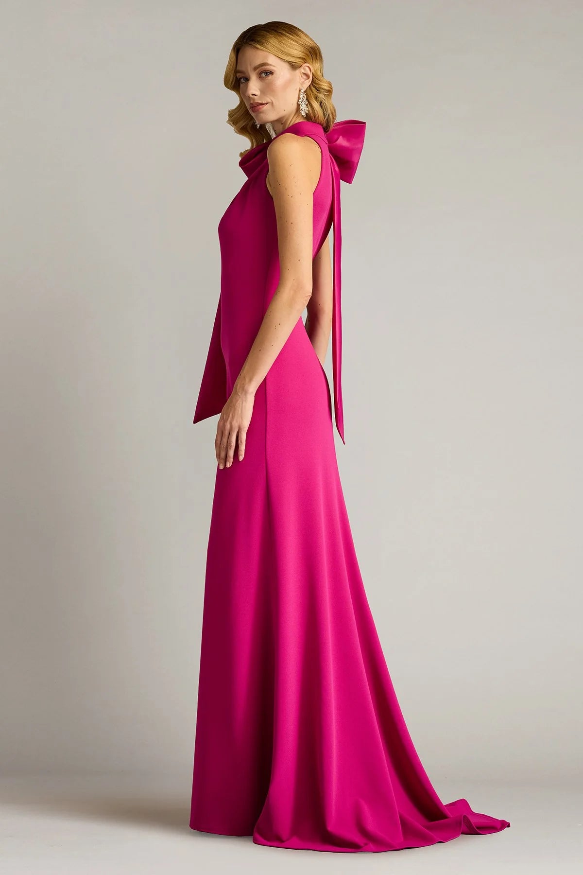 Sleek crepe sheath halter neck sleeveless open back floor length evening dress with oversized satin bow and train