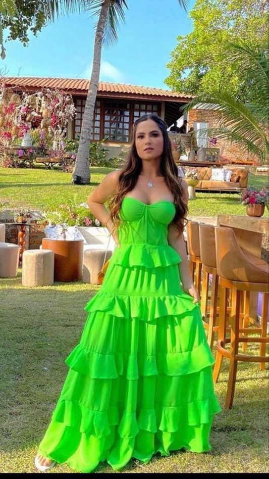 Model wearing a vibrant green A-line prom dress with tiered ruffles and a sweetheart neckline.