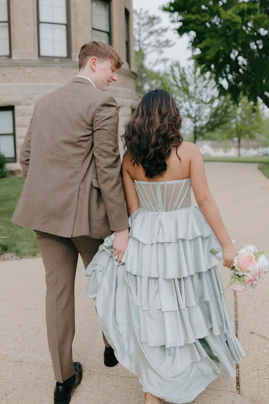 Back view of the whimsical tiered ruffled A-line evening dress with seamed corset and zipper closure.