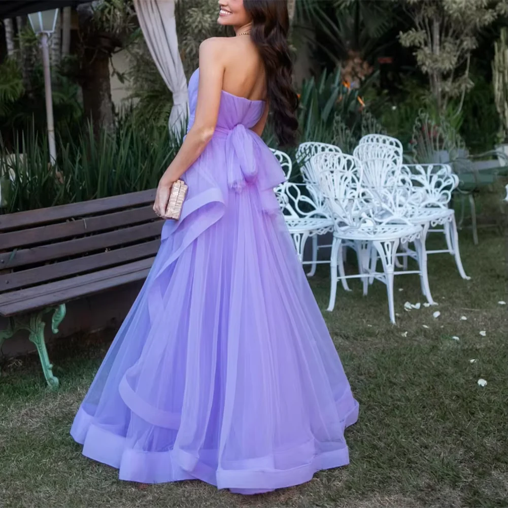 Side profile of the flowing lavender tulle A-line prom dress.