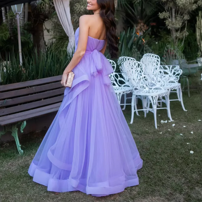 Side profile of the flowing lavender tulle A-line prom dress.