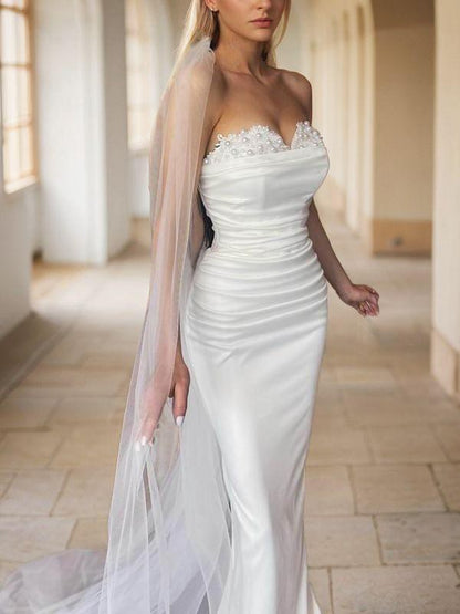 Tight off shoulder sweetheart beaded and ground length satin backless wedding dress